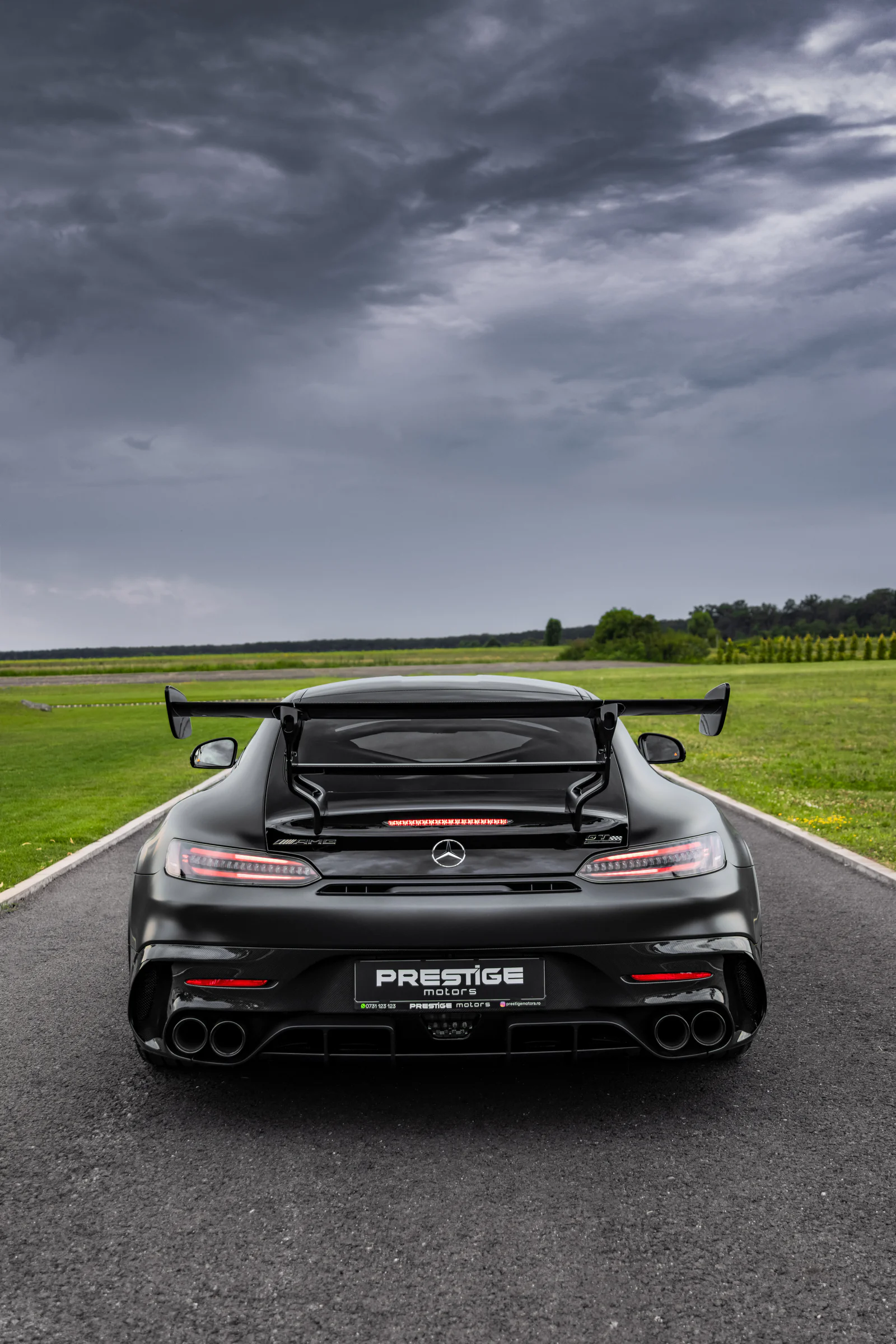 Rear portrait showing the double wing, taillights and four exhausts