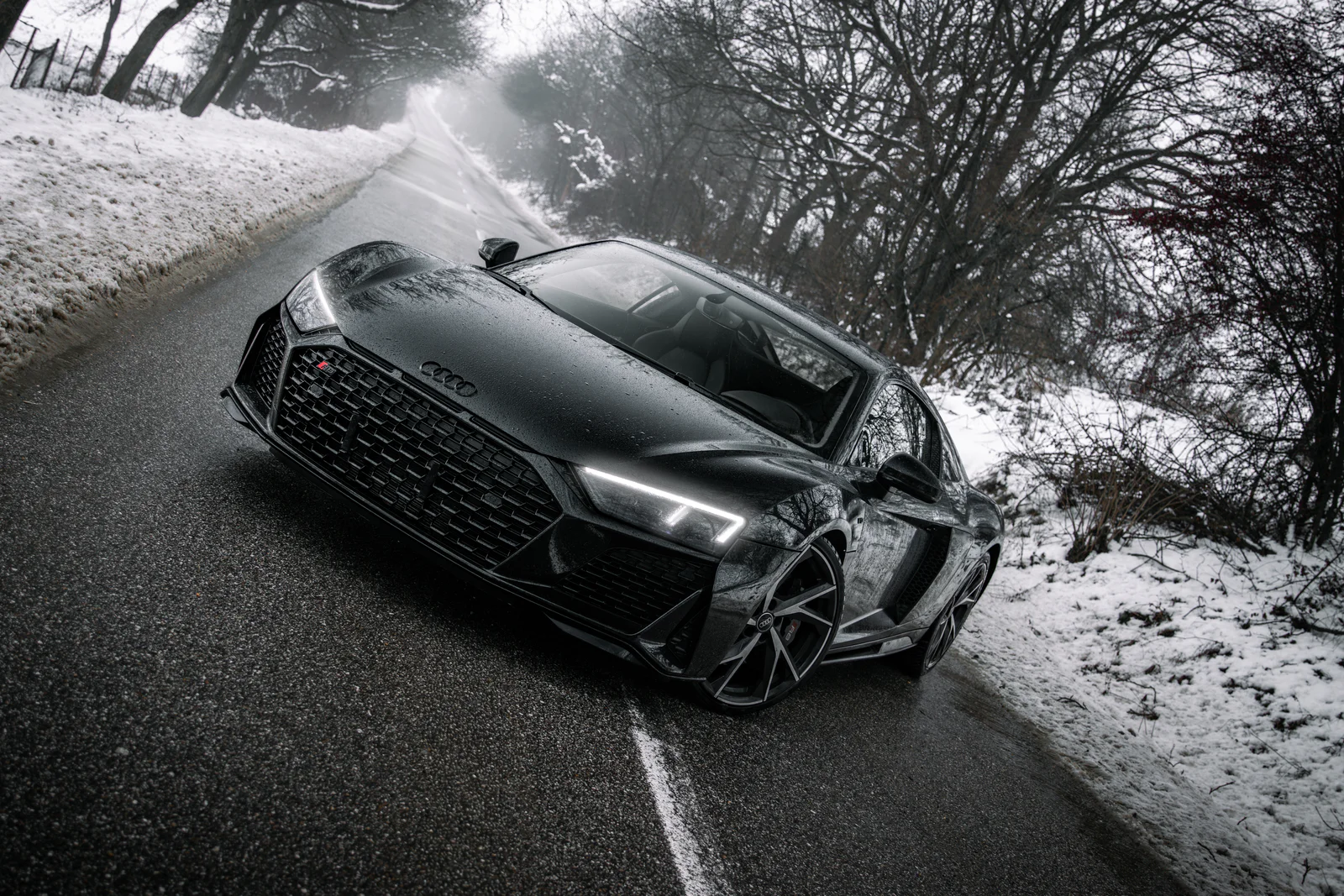 Diagonal front three-quarter view of the R8 on the winter road