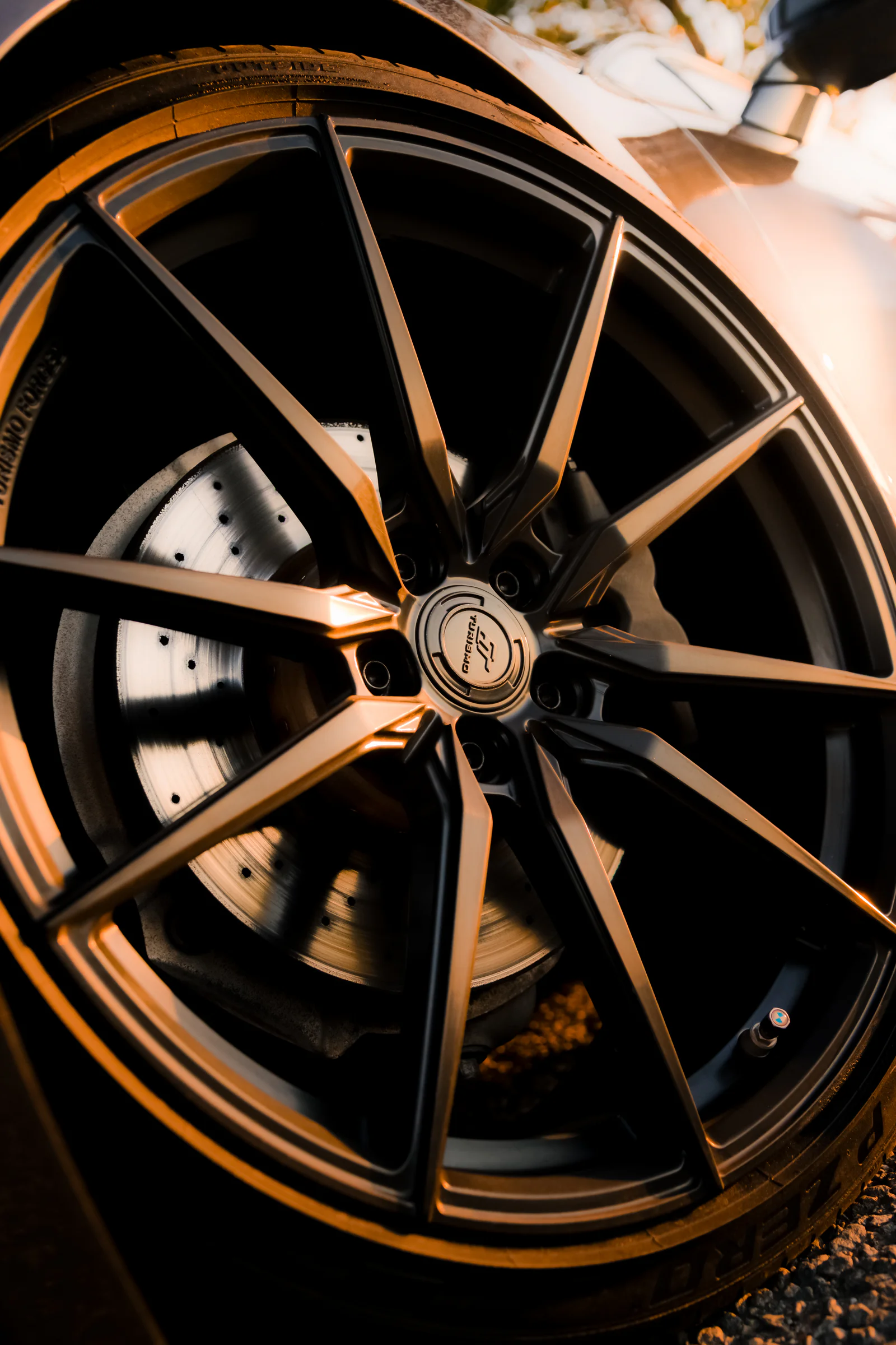 Close portrait of the alloy wheel spokes and drilled brake disc
