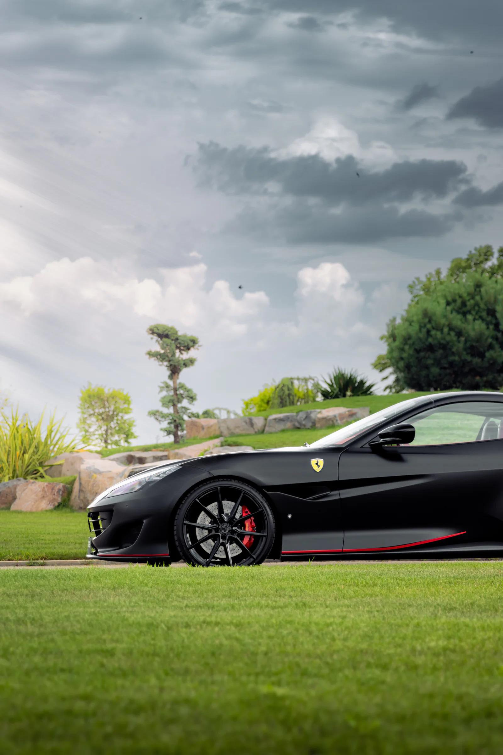 Portofino front wheel and side profile against green lawns and storm clouds