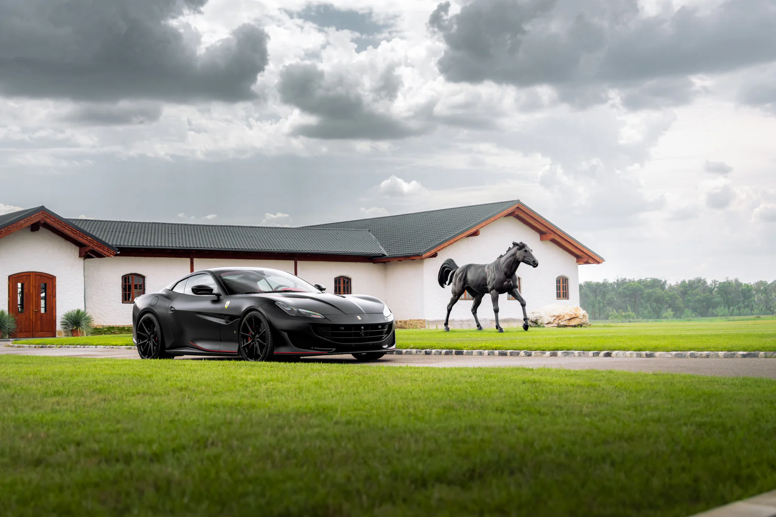 Front three-quarter view of the Portofino beside a horse sculpture and white buildings