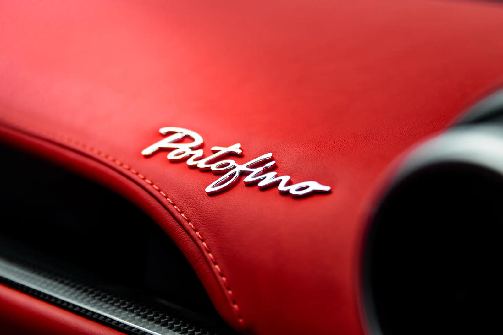 Chrome Portofino script on the red leather dashboard