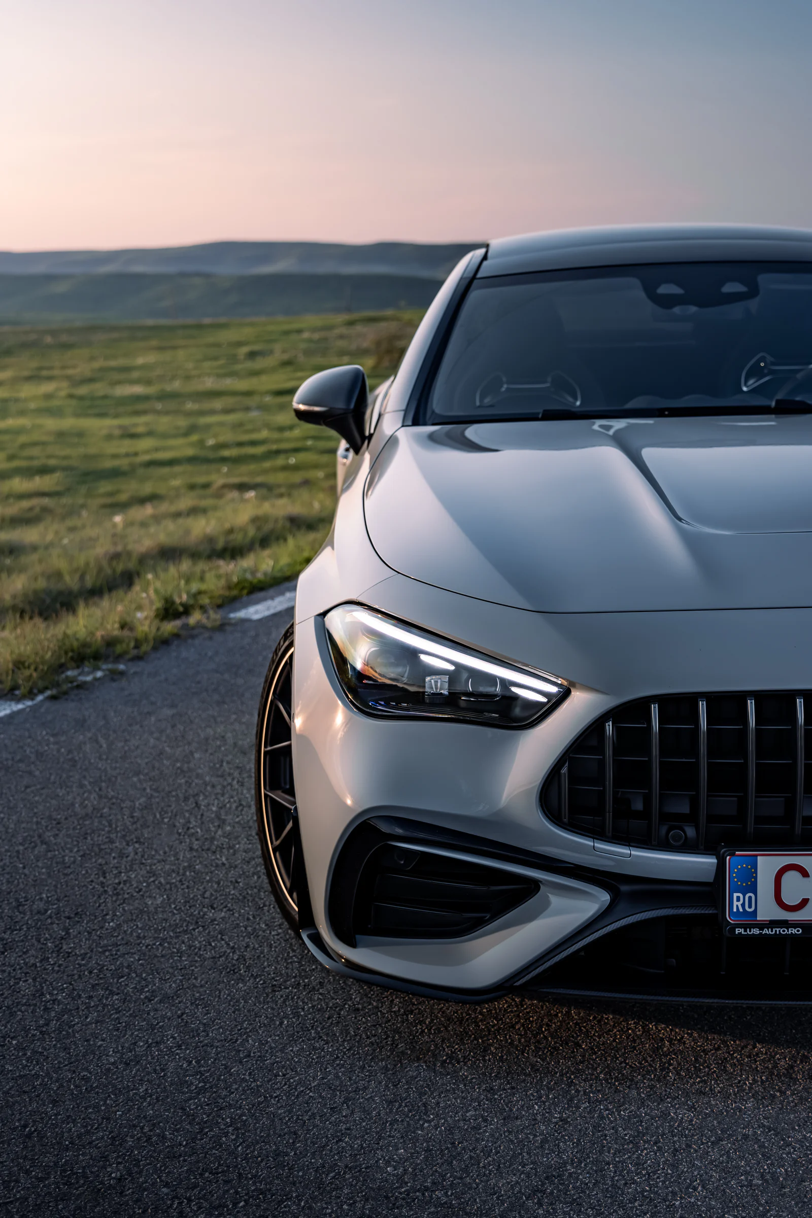 Close portrait of the front headlight, bonnet and AMG grille