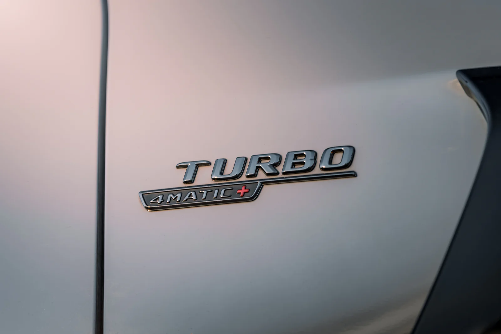 Turbo 4MATIC+ badge on the pearl-white front wing