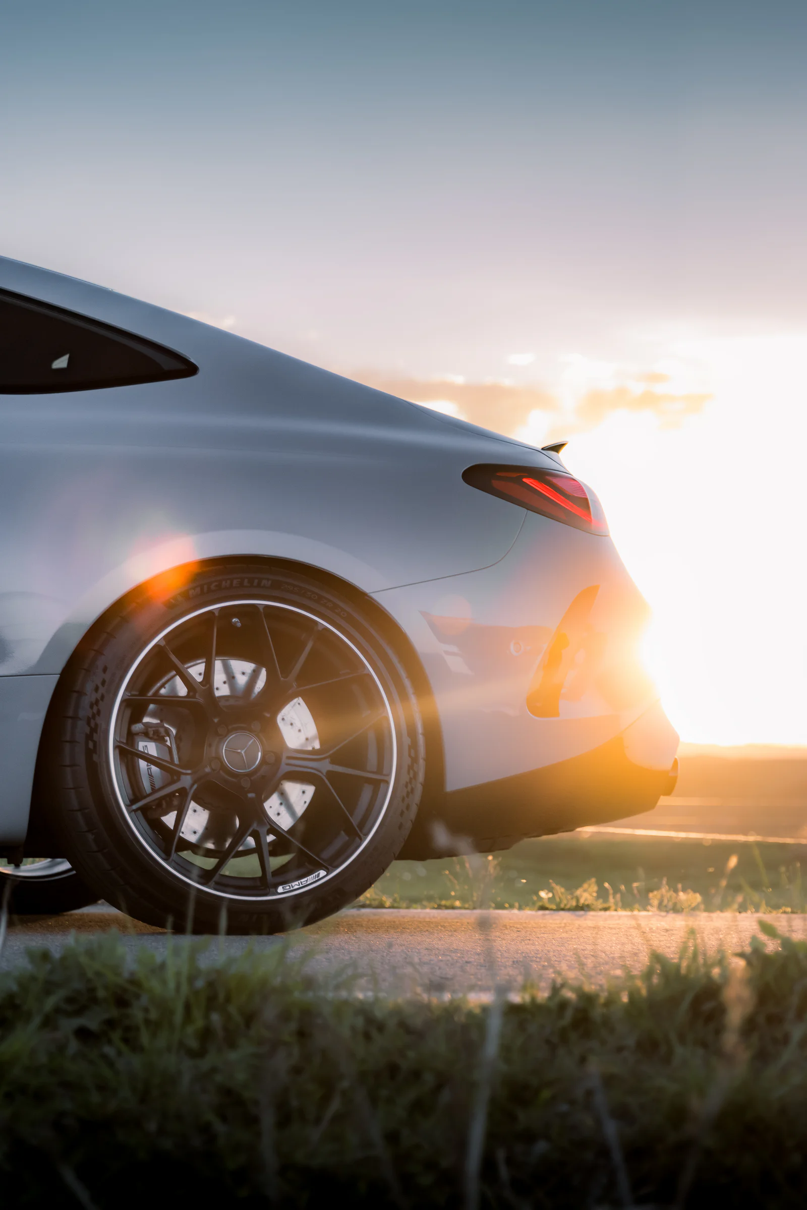 Rear wheel and taillight with warm sunlight spilling around the body