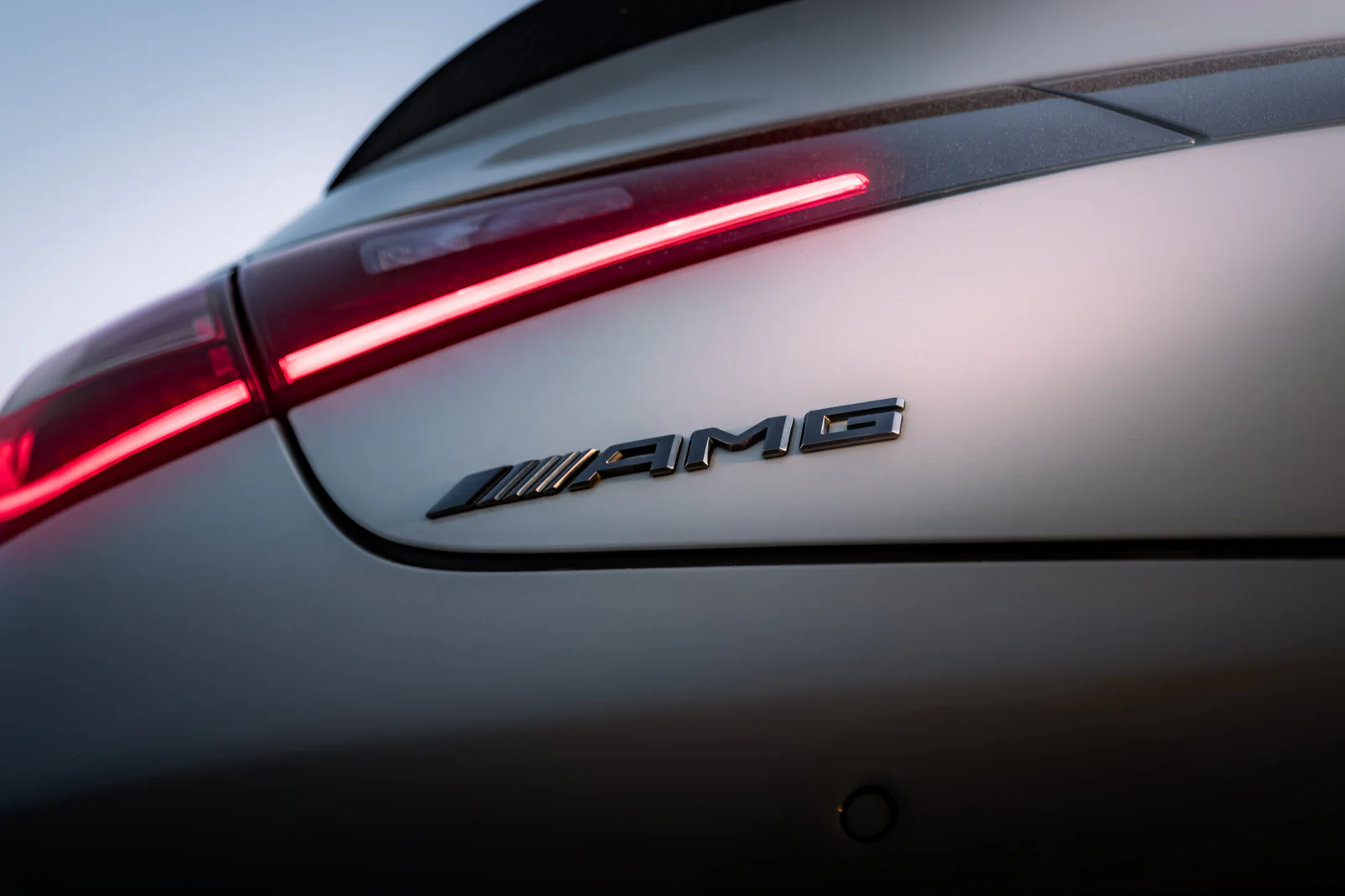 AMG rear badge and red light strip in evening light