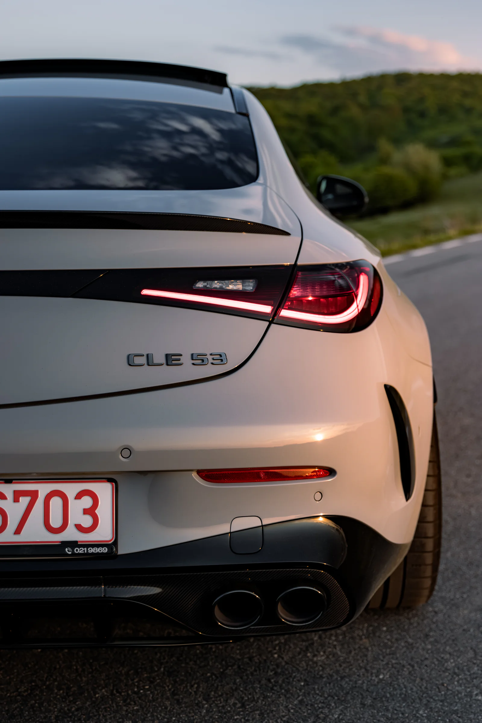 Rear-quarter portrait showing the taillight, spoiler and twin exhausts