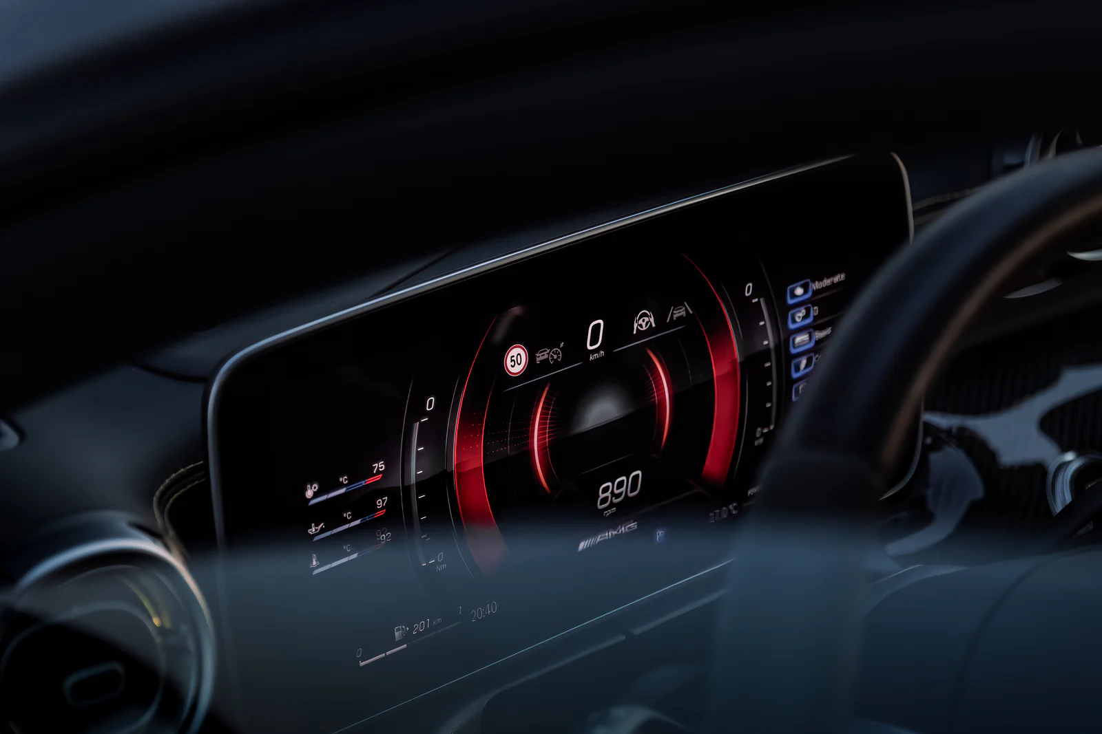 Red AMG digital instruments framed by the dark cockpit